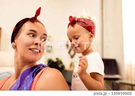 Happy mother and child enjoying playful moments together at home 130650008