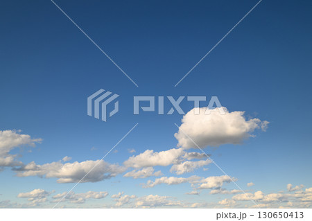 A Serene Blue Sky with Fluffy, Beautiful Clouds that Create a Peaceful Atmosphere Above A Serene Blue Sky with Fluffy, Beautiful Clouds that Create a Peaceful Atmosphere Above 130650413
