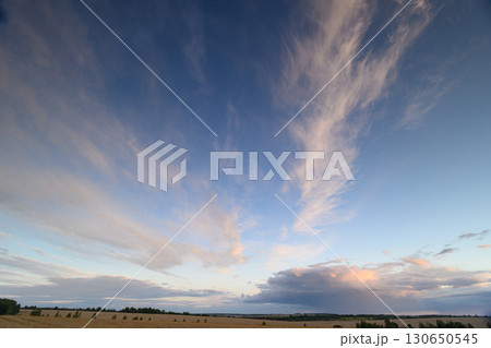 A Dramatic Sky Displayed with Colorful Clouds at Dusk, Perfect for Stunning Photography A Dramatic Sky Displayed with Colorful Clouds at Dusk, Perfect for Stunning Photography 130650545