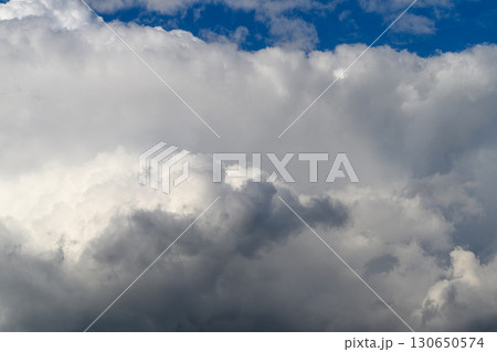 A breathtaking dynamic sky filled with fluffy clouds and vast blue expanse above 130650574