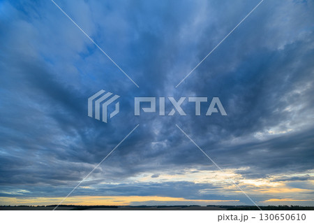 A stunningly dramatic sky filled with clouds during the beautiful dusk time of day 130650610