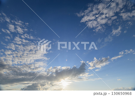 The Serene Sky is adorned with Wispy Clouds and bathed in warm, gentle Sunlight The Serene Sky is adorned with Wispy Clouds and bathed in warm, gentle Sunlight 130650968