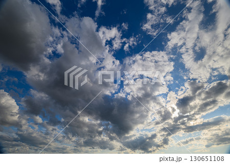 A Beautiful Dynamic Cloudscape Set Against a Vibrant Blue Sky, Full of Fluffy Clouds and Sunshine 130651108