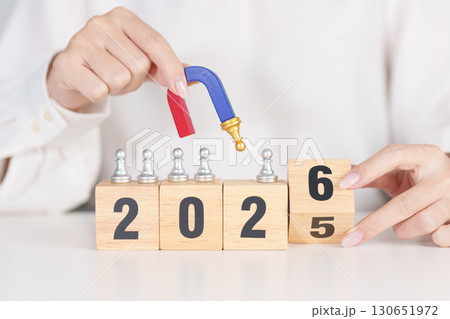 hand holding magnet and pulling man chess figure from the crowd employee with 2026 Year block. Human resource management, Recruitment, Teamwork, strategy, toxic people and leadership Concepts hand holding magnet and pulling man chess figure from the crowd employee with 2026 Year block. Human resource management, Recruitment, Teamwork, strategy, toxic people and leadership Concepts 130651972