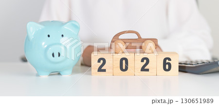 Happy New Year 2026 with car model and Coins Money stack for deposit and Automobile Tax. Money Saving, Car Insurance, Financial, vehicle Repair and Maintenance and New Year concept 130651989