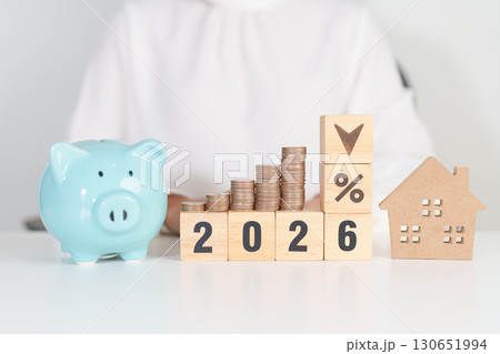 2026 New Year with percentage change to UP and Down arrow, Home model and coin stack. Real estate Mortgage, Refinance, House loan and debt, Interest rate, Insurance, Financial and Property Tax 130651994