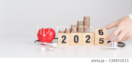 Happy New Year 2026 with doctor Stethoscope, coins stack and red heart on table. health care, Money saving, Goal, Resolution, health Insurance, Wellness and medical concept Happy New Year 2026 with doctor Stethoscope, coins stack and red heart on table. health care, Money saving, Goal, Resolution, health Insurance, Wellness and medical concept 130652013