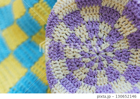 Violet and yellow squares in checkerboard pattern on crochet yellow and blue squares in checkerboard in blue background Violet and yellow squares in checkerboard pattern on crochet yellow and blue squares in checkerboard in blue background 130652146