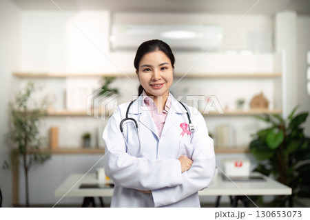 Breast Cancer Awareness. Smiling female doctor with arms crossed in modern clinic. 130653073