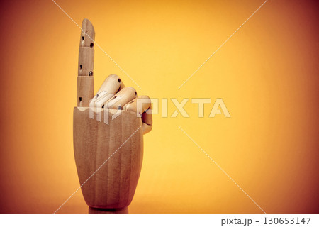 Wooden hand pointing up close-up 130653147