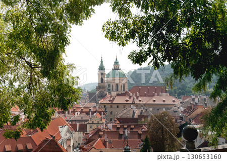 The stunning st. Nicholas church towering over the picturesque red rooftops of Prague 130653160