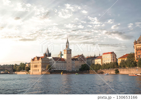 Sunny summer day: tourists delighting in a Vltava river boat excursion with stunning Prague landmarks. Czech Republic Sunny summer day: tourists delighting in a Vltava river boat excursion with stunning Prague landmarks. Czech Republic 130653166