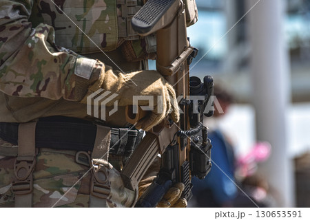 Soldier holding modern assault rifle with scope and tactical gear Soldier holding modern assault rifle with scope and tactical gear 130653591