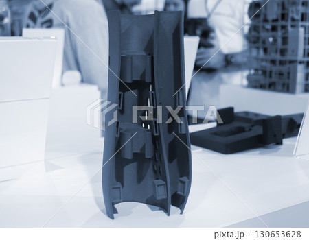 Object printed on 3D printer from molten plastic powder close-up. Model of black color printed on 3D printer from melted polyamide powder. Modern additive 3D printing technology. Multi Jet Fusion MJF 130653628