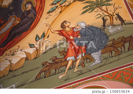 Young man showing something to an old shepherd and pointing with a finger in a vivid biblical scene painting 130653634