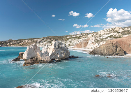 Turquoise waters gently lap the rocky shore of aphrodite's rock beach in cyprus 130653647