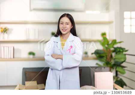 Breast Cancer Awareness. Confident healthcare professional with pink ribbon. 130653689