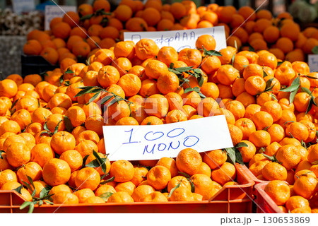 Fresh tangerines with leaves displayed at the market Fresh tangerines with leaves displayed at the market 130653869