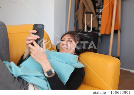 an adult woman listening music at her home in headphones, lifestyle people an adult woman listening music at her home in headphones, lifestyle people 130653901
