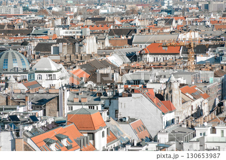 Construction crane rising above the rooftops of Budapest city on a sunny day Construction crane rising above the rooftops of Budapest city on a sunny day 130653987