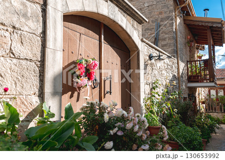 Old wooden door with flower wreath in Vouni village, Cyprus Old wooden door with flower wreath in Vouni village, Cyprus 130653992