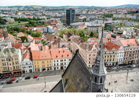 St. Bartholomew cathedral steeple overlooking picturesque Old Town of Plzen square with colorful buildings. Czech Republic 130654119