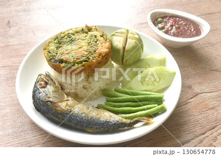 batter fried egg stuffed acacia and mackerel with fresh vegetable on rice in plate dipping spicy shrimp paste sauce 130654778