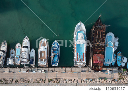 Variety of boats are docking at a pier, creating a colorful and dynamic scene. Ayia Napa, Cyprus 130655037