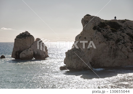 Couple admiring Aphrodite's Rock (Petra tou Romiou) at sunset in Cyprus. Paphos District 130655044