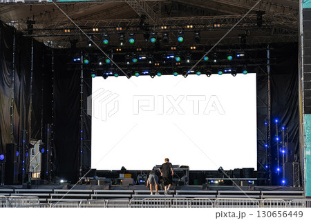 Stage crew setting up concert production with massive LED screen Stage crew setting up concert production with massive LED screen 130656449