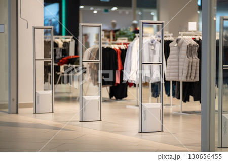 Radio-frequency security gates with integrated metal detector at a clothing store entrance Radio-frequency security gates with integrated metal detector at a clothing store entrance 130656455