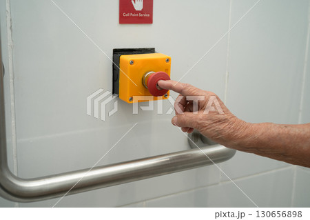 Asian elderly woman press emergency button in toilet. 130656898