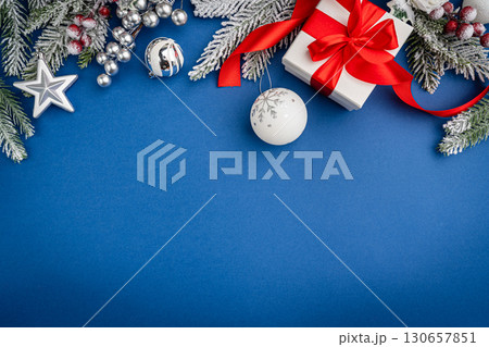 Christmas Gifts and Silver Ornaments on Blue Background 130657851