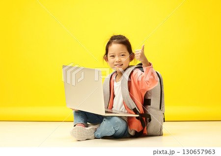 Enthusiastic Korean Child showing thumb up, Thrives in Online Learning. Adorable Japanese Kid Excels in Digital Classroom 130657963