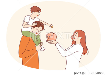 Teaching child financial literacy in young family, using pig piggy bank to save money 130658889