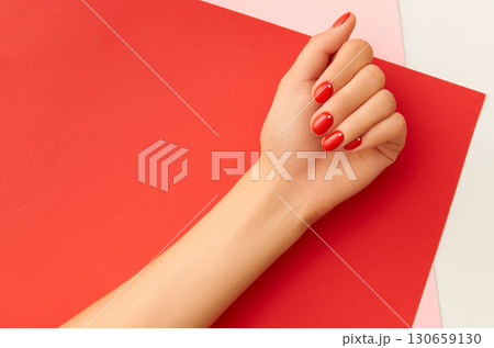 Womans hands with red manicure. Minimalist nail design 130659130