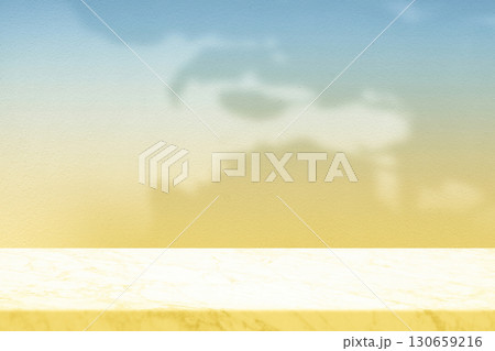 Empty Marble Table Top with Sun Shade and Blue Yellow Gradient Wall Background. Empty Marble Table Top with Sun Shade and Blue Yellow Gradient Wall Background. 130659216