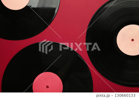 Gramophone vinyl records on red background. Gramophone vinyl records on red background. 130660133