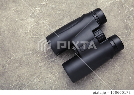 Binoculars on grey concrete background. Top view. Space for text 130660172