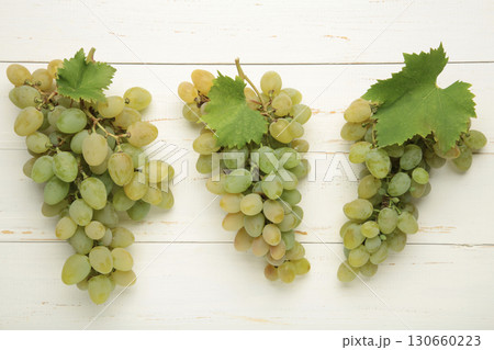 Fresh green grape on white wooden background. Fresh green grape on white wooden background. 130660223