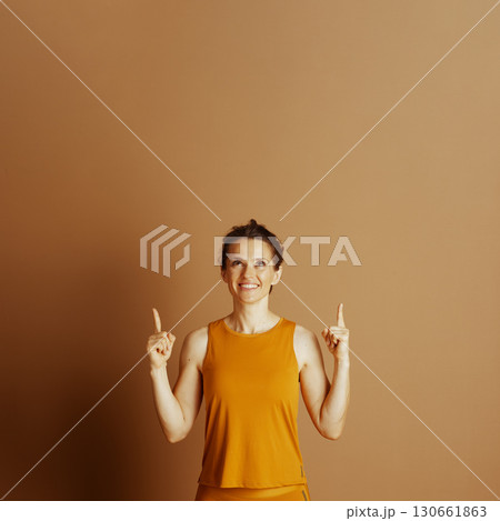 Upward Pointing: Enthusiastic Woman in Mustard top Upward Pointing: Enthusiastic Woman in Mustard top 130661863