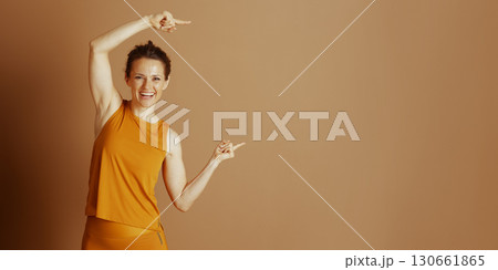 Pointing the Way: Cheerful Woman in Orange 130661865