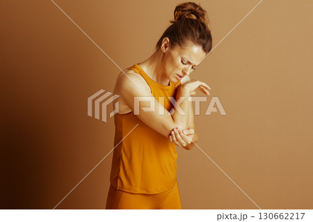 Woman with Elbow Injury and Pained Expression 130662217