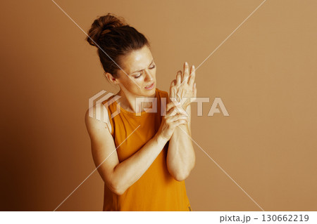 Woman with Pained Expression and Wrist Pain 130662219