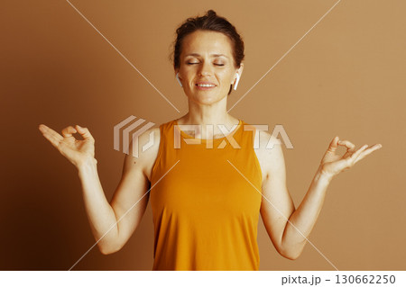 Serene Woman Meditating with Earbuds 130662250