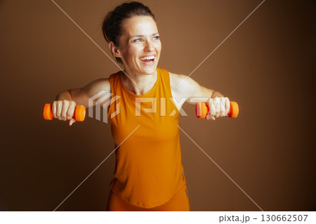 Strong Woman Performs Chest Fly Exercise 130662507