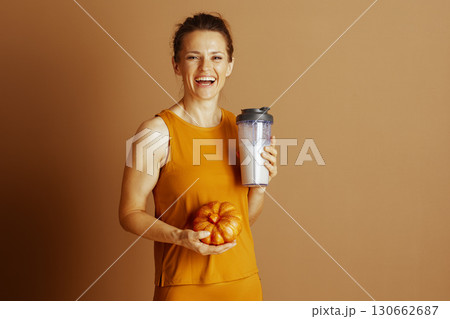 Autumn Nutrition: Woman with Shaker and Pumpkin Autumn Nutrition: Woman with Shaker and Pumpkin 130662687