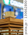 A cup of coffee on wooden decorative bar stand in coffee shop, close-up, vertical image, selective focus. 130662800