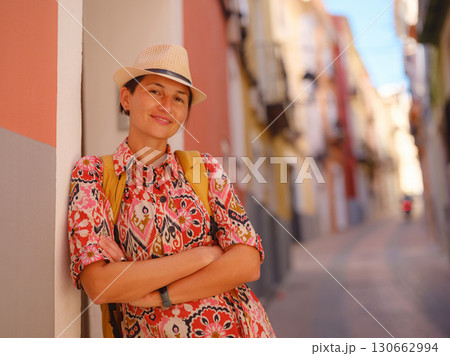 Woman strolls through colorful streets of Spanish coastal town Woman strolls through colorful streets of Spanish coastal town 130662994