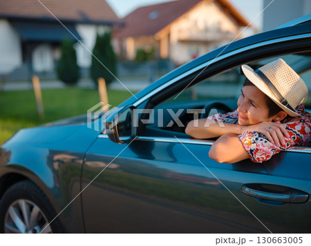 Traveler woman drives car through scenic countryside of Croatia 130663005